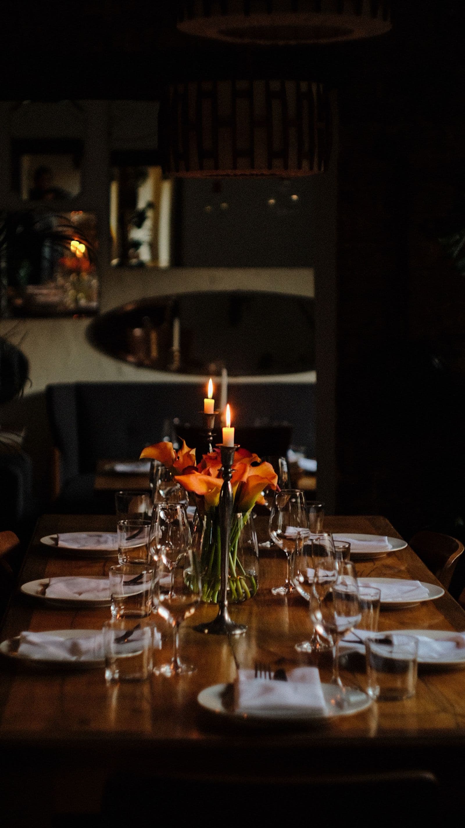 Candlelit fine dining table set for dinner